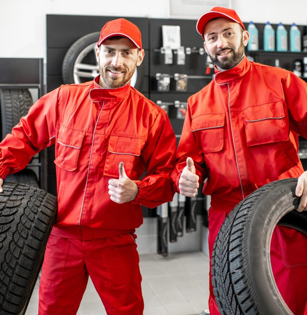 car service workers with new tires at the shop.jpg